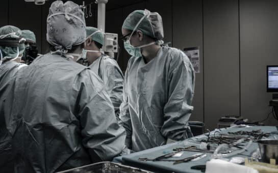 a group of doctors and medical professionals in an operating room