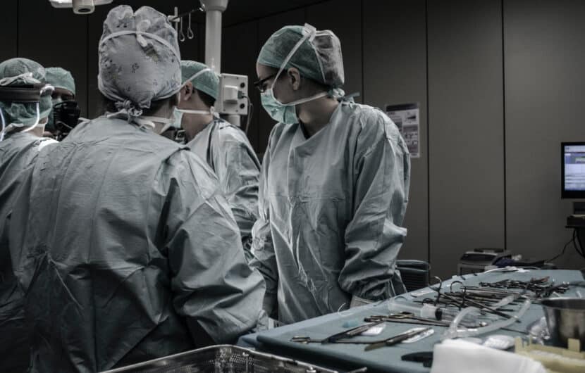 a group of doctors and medical professionals in an operating room